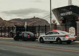 A police car pulls over a civilian and the driver is asked for his work travel permit according to the new regulations under level 3 lockdown. How will alert level 3 regulations affect how you travel?
